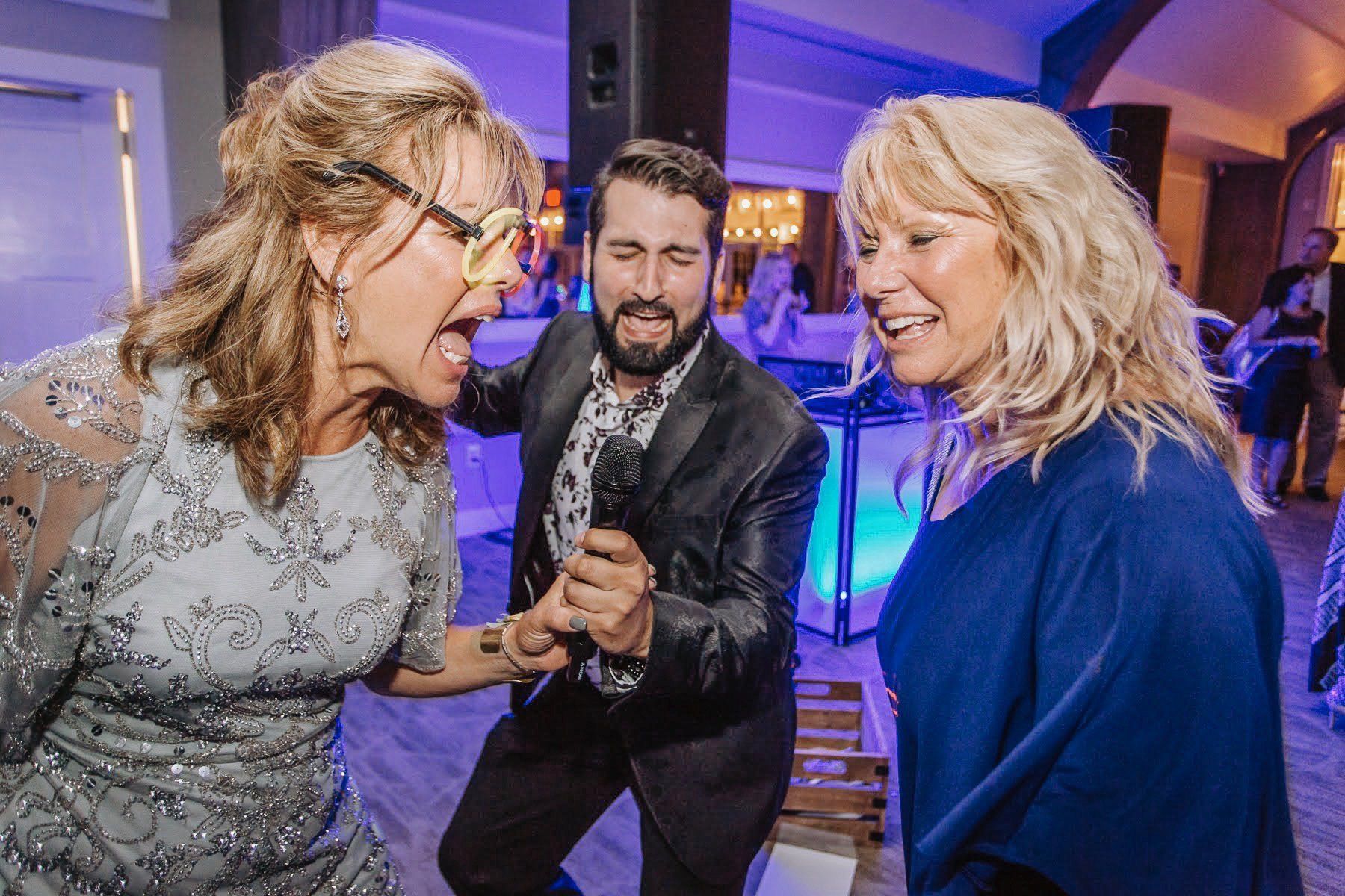 Guests singing along with a performer at a Big Day party